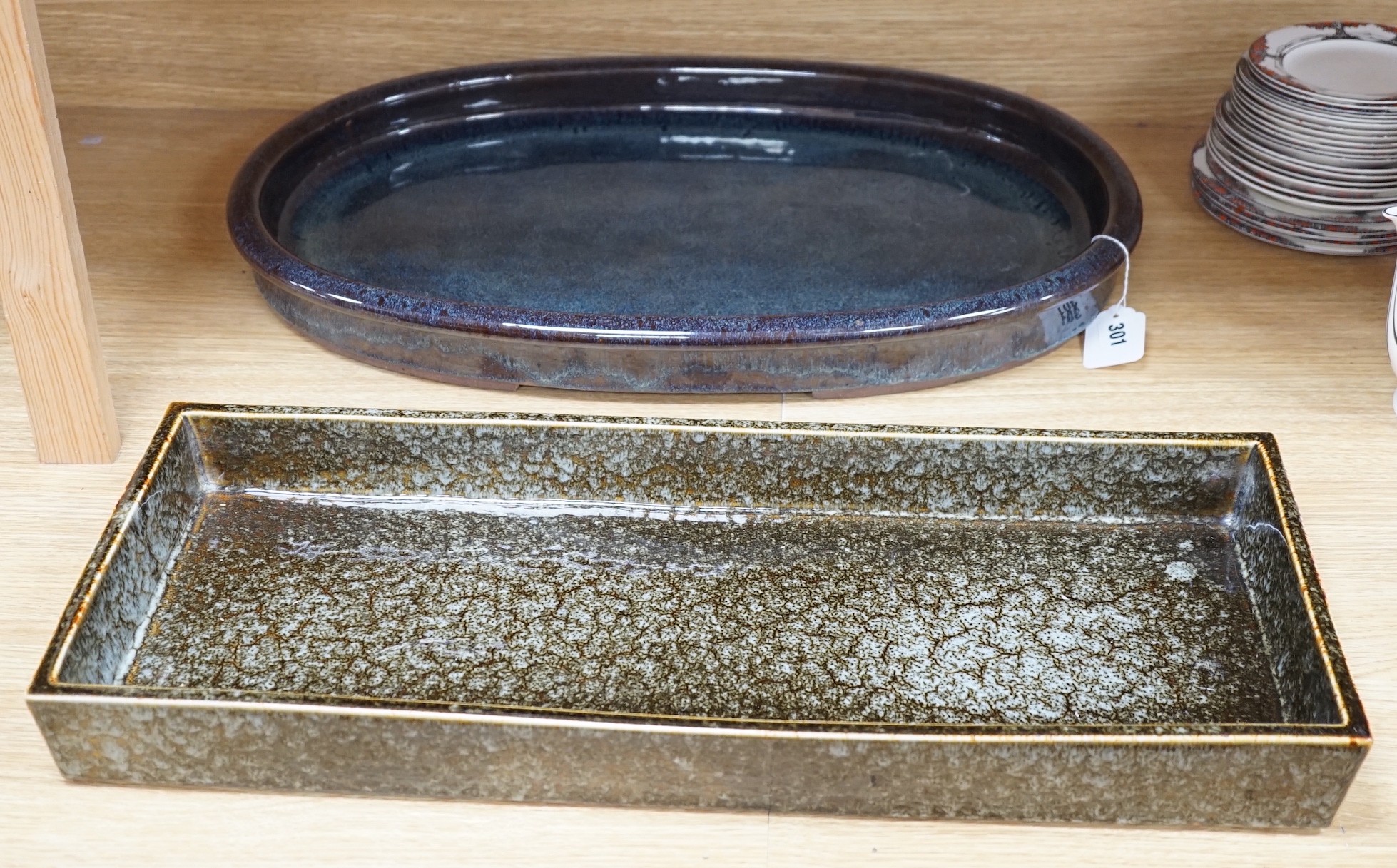 A large Japanese studio pottery oval dish and a larger studio pottery rectangular dish, largest 60cms wide x 24.5cms deep